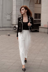 A lady walks quickly in an old money aesthetic costume.